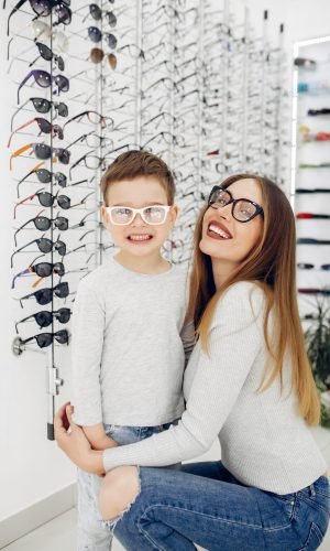 Mother with cute son. Family buy glasses